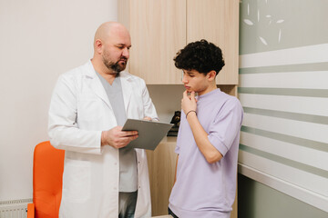 Fototapeta premium Patient discussing urinary tract health with urologist during exam.