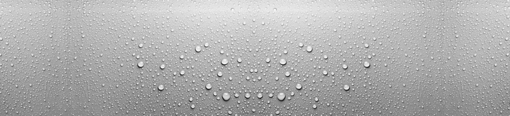 Panoramic texture of fresh clear water droplets condensing on a smooth grey metallic surface or...