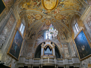 Fototapeta premium Urbino's Oratory of San Giuseppe interior boasts exquisite Baroque frescoes by Carlo Roncalli, a majestic pipe organ by Sebastiano Vici, and significant paintings