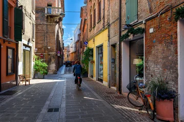 Fotobehang Fiets Cozy narrow street with bicycl in Ferrara, Emilia-Romagna, Italy. Ferrara is capital of the Province of Ferrara  © Ekaterina Belova