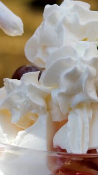 Garnishing no-bake strawberry shortcake trifle in jar with leaf of fresh mint; easy homemade dessert made with fresh strawberries and topped with whipped cream. High quality 4k footage