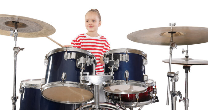 Little girl learning how to play drums on white background