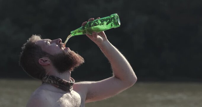 Drinking beer at the beach enthusiastically