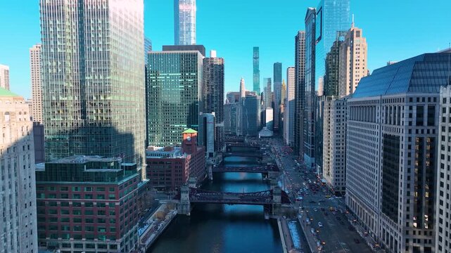 Drone Flying Between Downtown Chicago River Skyscrapers, Sunny Winter Afternoon Aerial of The Loop, Cinematic 4K