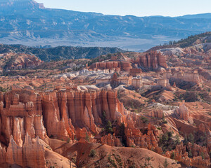 Bryce Canyon Pinnacles and Beyond. A wide landscape of desert pinnacles with mountains in the background.