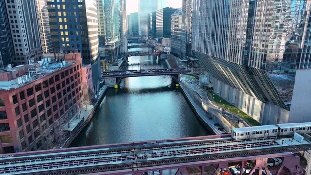 Drone Flying Between Downtown Chicago River Skyscrapers, Sunny Winter Afternoon Aerial of The Loop, Cinematic 4K