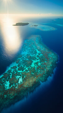 Aerial View Of Turquoise Coral Reef Near Tropical Islands
