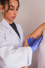 Naklejka premium Doctor performing breast examination for cancer detection