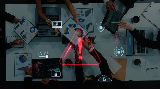 A collaborative workspace where business professionals evaluate data and address potential security threats, highlighted by a prominent warning symbol. Raster