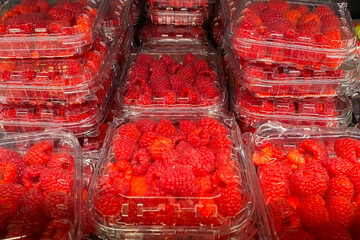 Fresh Red Raspberries in Clear Plastic Containers at Market