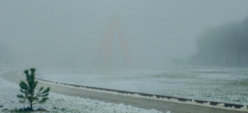A memorial to Soviet soldiers in a foggy field