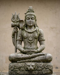 Fototapeta premium Stone Statue of Lord Shiva Meditating with Trident and Cobra