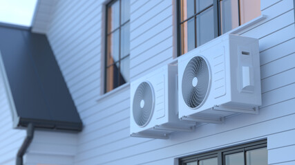 Modern air conditioning units installed on exterior wall of residential house