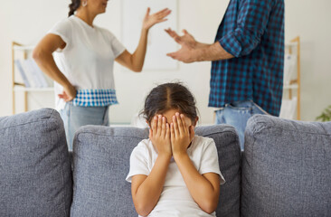 Kids hands hide face amid parental conflict and fight at home. Angry father and mothers arguments...