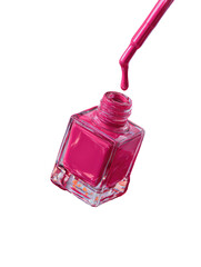 Vibrant pink nail polish drips from brush over open bottle, black background
