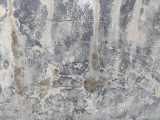 Industrial grunge background of a distressed grey cement wall featuring moisture damage, mineral deposits, and rustic weathered texture.