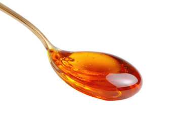 Spoonful of golden liquid with dark background, lit from above