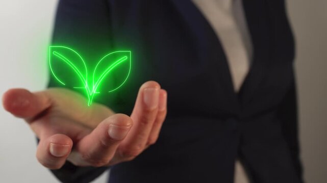 Woman's hand holding a virtual plant icon in neon light	
