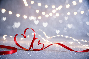Heart ribbon on glittering background with bokeh lights. Elegant romantic love scene.