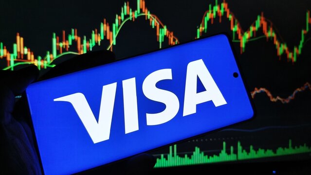 Close-up of hand holding smartphone with Visa logo on screen