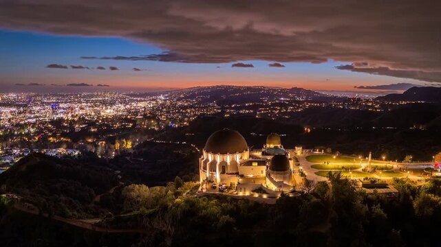 Griffith Observatory overlooking city of Los Angleles cityscape at sunset. Aerial timelapse view.