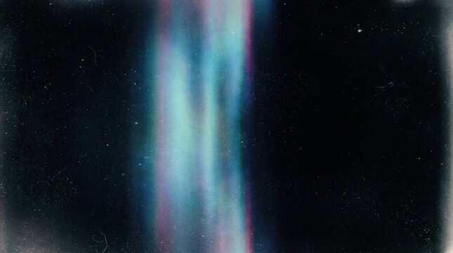Abstract colorful light leak flare effect glowing vertically on a grainy dark background with grunge dust and scratches texture for vintage film overlay design.