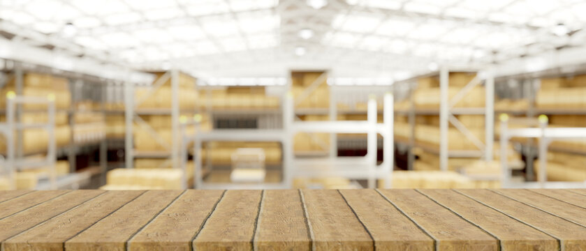 Empty wooden table or bench across crate boxes on metal shelves in modern factory or goods warehouse