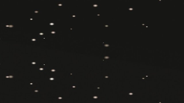Floating Dots in Dark Studio Lighting