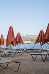 Relaxation on the beach with umbrellas and lounge chairs near the water at a resort in the afternoon