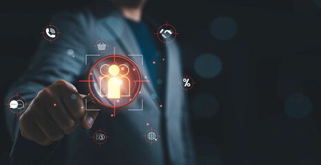 Businessman using magnifying glass to identify customers representing Customer Relation Management or CRM marketing strategy, client segmentation and Customer targeting audience analysis concept.