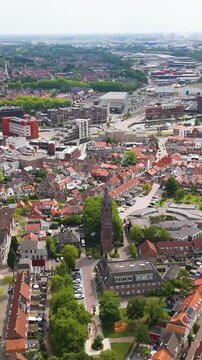 dense patchwork red tiled roofs historic brick buildings sits along curve industrial waterway cuts through landscape terneuzen port netherlands wide town red-tiled urban cityscape 