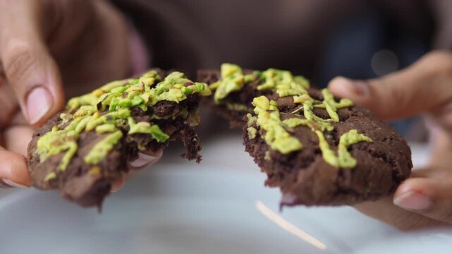 Enjoying a large chocolate cookie with toppings