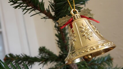 Golden jingle bell symbolizing christmas holiday festivity