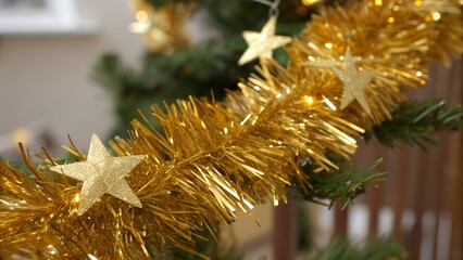 Golden tinsel star decorations. perfect for festive celebrations. Close-up shot detailed