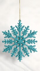 Hanging turquoise snowflake ornament festive winter decoration isolated on white background