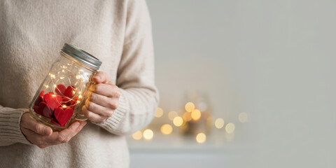 Hand jar love emotion thank with gratitude bokeh light charity care holiday concept valentine gift nubes shimmer in heartwarming scene of glowing heart shape in glass container
