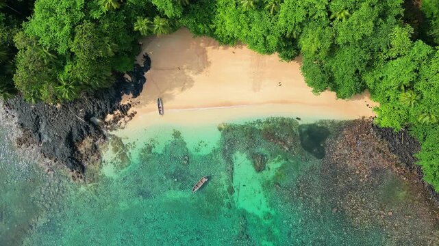Descending onto the beautiful Margarida beach with its turquoise sea and a falcon flying around the sand. Prince Island,S&atilde;o tom&eacute;,Africa