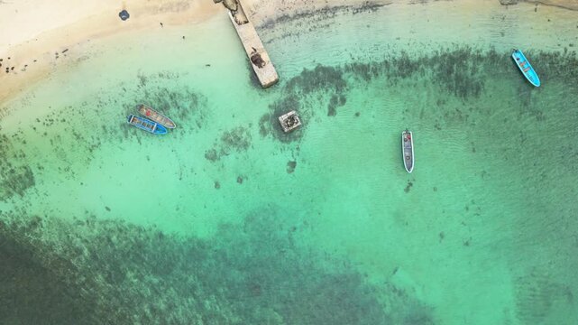 Descending over boats anchored in the transparent sea of Ilheu das Rolas,S&atilde;o Tom&eacute;,Africa