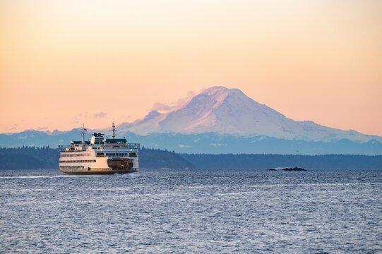 Two Washington state ferries at sunrise with Mount Rainier in the background