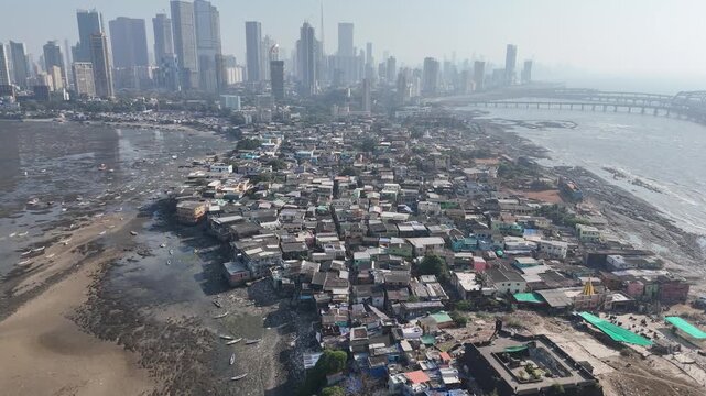Mumbai, India &ndash; January 25, 2026 &ndash; Aerial drone view of Worli Village coastal settlement with high-rise skyline and bridges.