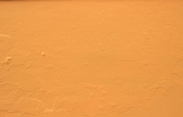 The old cement wall surface is painted golden yellow.