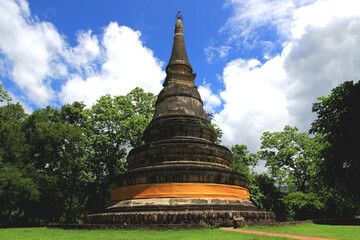 Fototapeta premium The beautiful stupa is a sacred object in the temple, a place of worship for Buddhists, against a stunning sky backdrop.