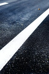 White line on dark asphalt road surface image