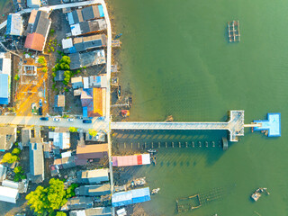 Aerial view top view of the fisherman village with fishing boats and house roof at the pier in Phangnga Thailand, Panorama high angle view