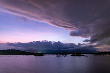 Landscape view of majestic clouds in the sky sunset or sunrise over sea