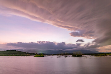 Landscape view of majestic clouds in the sky sunset or sunrise over sea