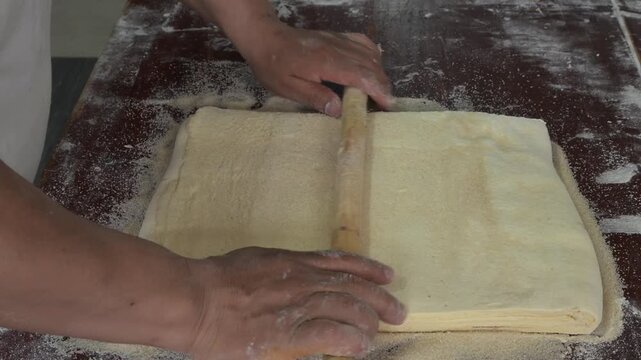 ADDING SUGAR TO THE DOUGH TO PREPARE SWEET BREAD