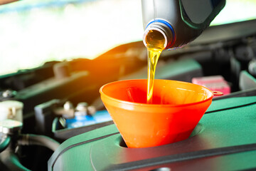Refueling and pouring oil quality into the engine motor car Transmission and Maintenance Gear...