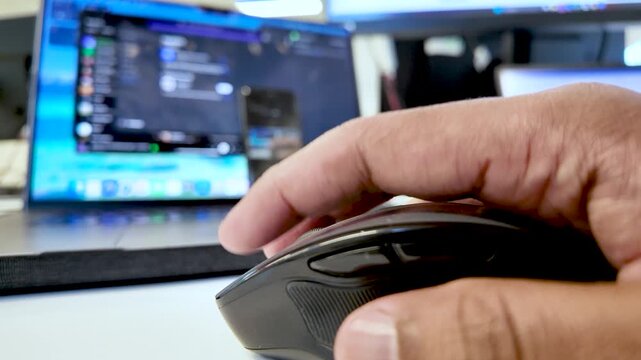 Close Up Of Finger Pressing Black Mouse Button With Laptop In Background For Online Gaming Or Remote Work Technology And Connectivity Concepts