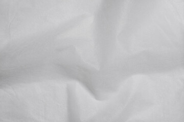 Obraz premium White nonwoven fabric background texture with subtle wavy wrinkles